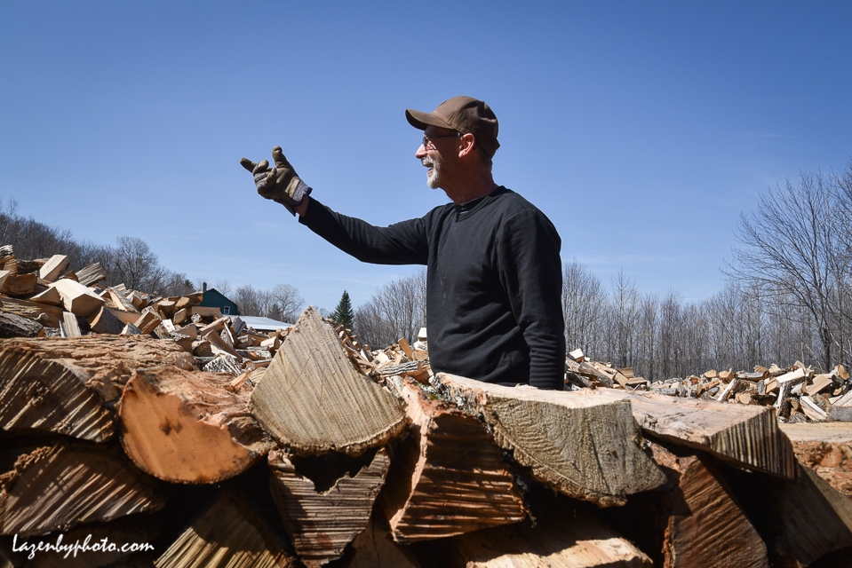Roger Chaloux stacks wood.