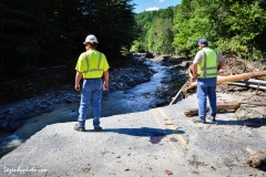 Workmen gaze into the gap where Camp Brook destroyed Camp Brook Road, Bethel, VT, one route into the town of Rochester.