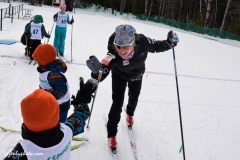 World Cup USST skier Ida Sargent, home for the holidays and the Tour de Ski break, high fives a BKL lollipoper after the lollipop run. NENSA Eastern Cup, COC. VT.