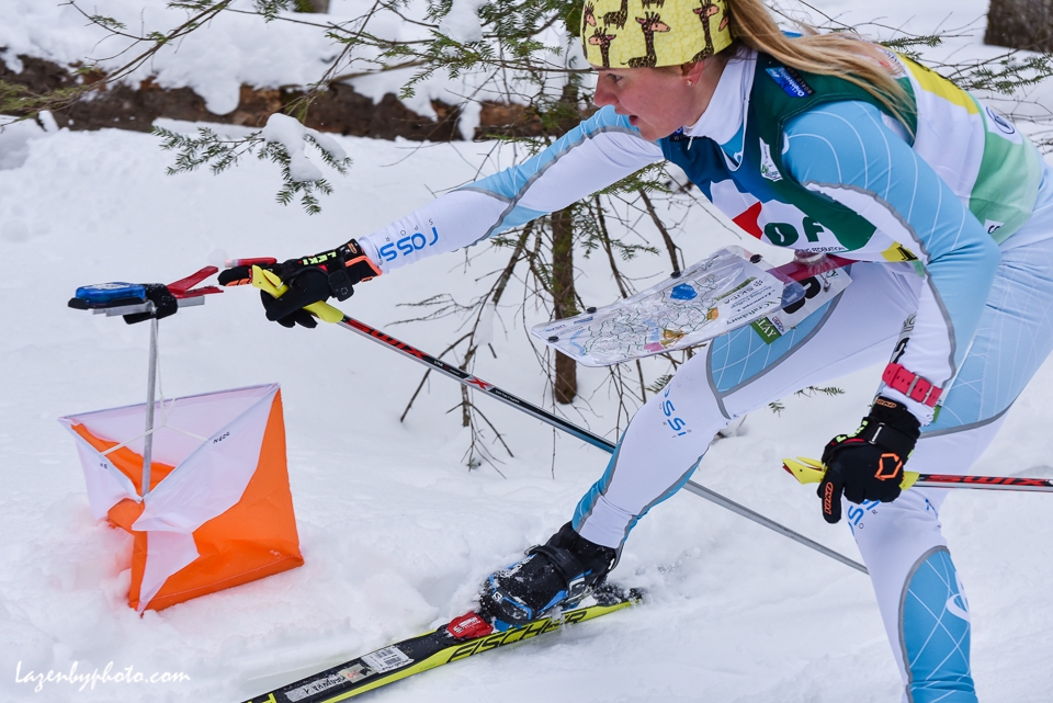 The eventual silver medalist Russian Tatyana Oborina hits a checkpoint  in the mixed relay at the at the International Orienteering Federation World Cup at Craftsbury Outdoor Center, Craftsbury, VT. She teamed with Eduard Khrennikov .