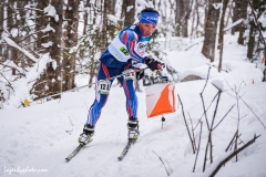 The eventual silver medalist Russian Eduard Khrennikov hits a checkpoint  in the mixed relay at the at the International Orienteering Federation World Cup at Craftsbury Outdoor Center, Craftsbury, VT. He teamed with Tatyana Oborina.