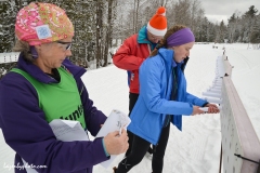Volunteers roll maps for the map exchange in the distance race at the International Orienteering Federation World Cup at Craftsbury Outdoor Center, Craftsbury, VT.
